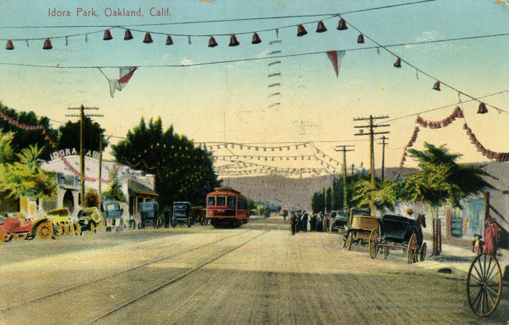 Postcard of Idora Park, featuring a broad boulevard with a streetcar and a few early automobiles on the sides!.